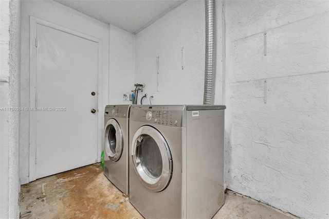 clothes washing area featuring laundry area and washing machine and clothes dryer