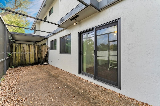 view of home's exterior featuring fence and stucco siding