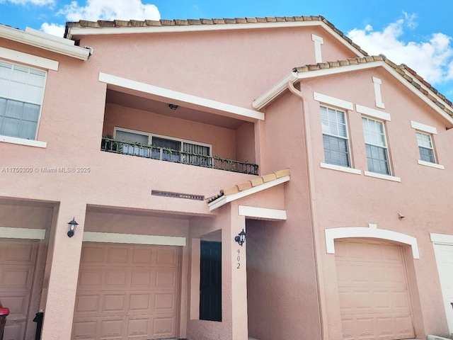 view of property featuring a balcony and stucco siding