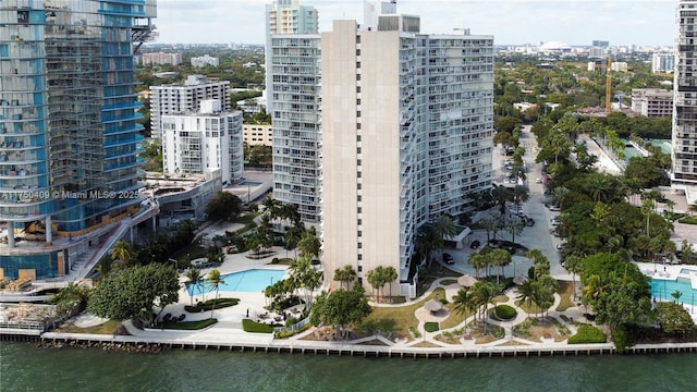 birds eye view of property with a view of city and a water view