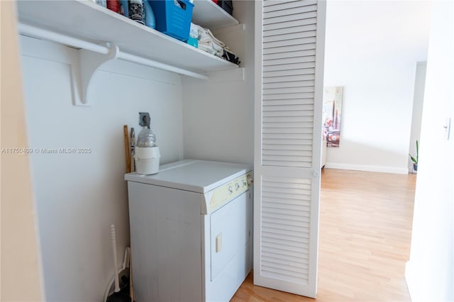 laundry room featuring washer / dryer, laundry area, and light wood-style flooring