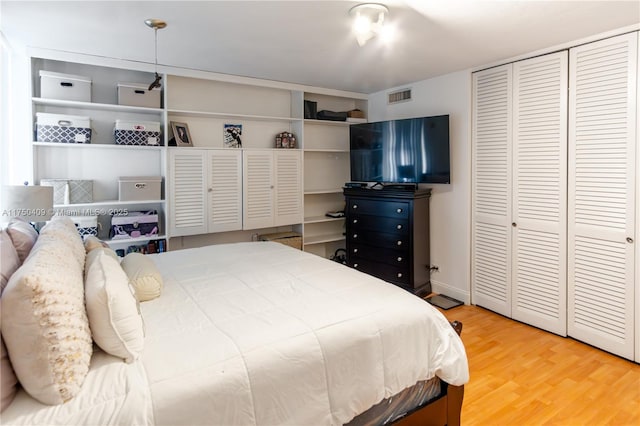 bedroom with visible vents and wood finished floors