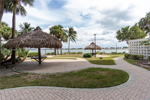 view of community featuring a gazebo, a yard, and a water view