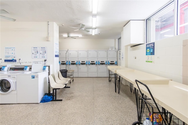 community laundry room featuring concrete block wall, ceiling fan, and separate washer and dryer