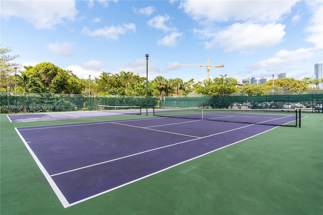 view of sport court featuring fence