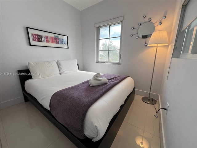 bedroom featuring tile patterned floors and baseboards