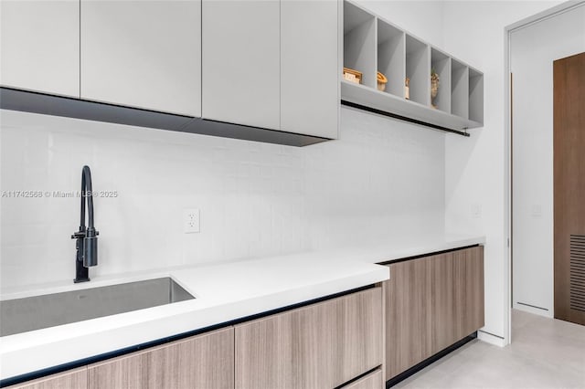 kitchen featuring modern cabinets, open shelves, and light countertops