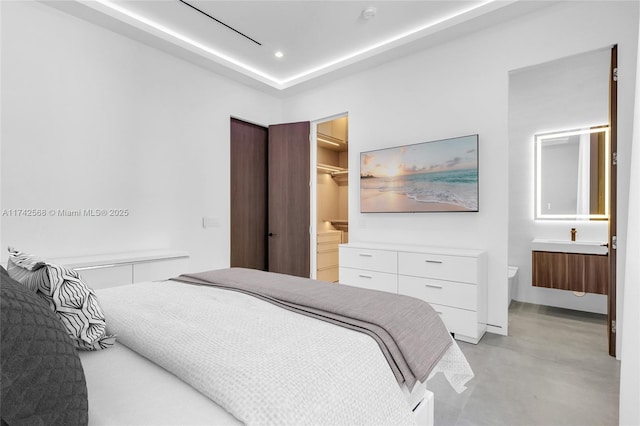 bedroom featuring finished concrete floors and recessed lighting