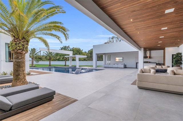 view of patio with an outdoor hangout area and a fenced in pool