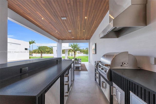 view of patio / terrace with exterior kitchen and a grill