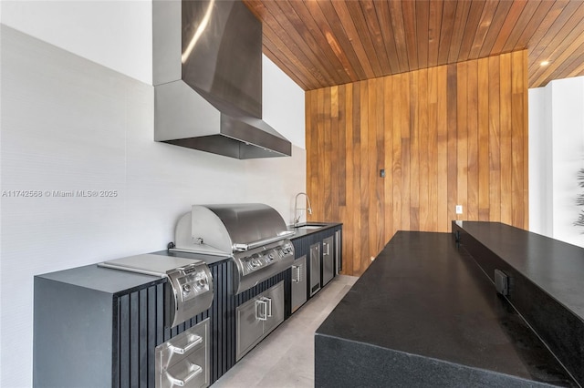 view of patio / terrace with exterior kitchen, a grill, and a sink