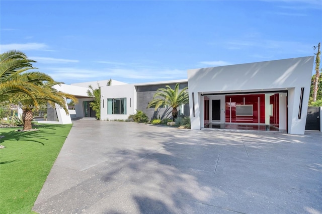 view of front of home with a front yard and stucco siding