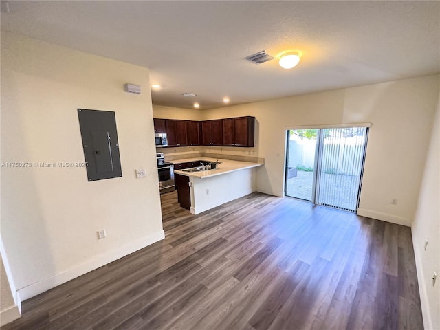 kitchen featuring stainless steel appliances, light countertops, visible vents, dark brown cabinets, and electric panel