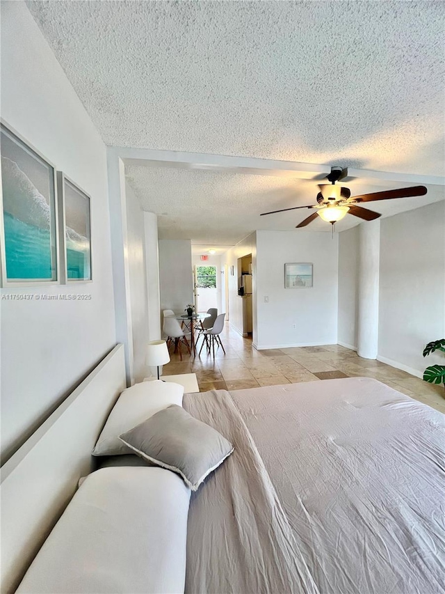 bedroom featuring a ceiling fan and a textured ceiling