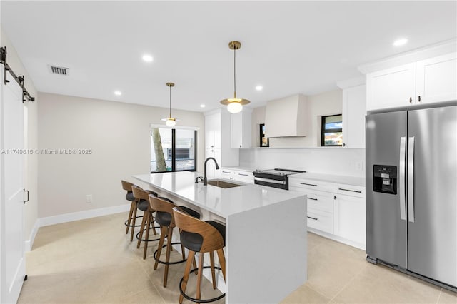 22274 SW 61st Ave, Boca Raton, FL 33428 - kitchen with stainless steel fridge, electric range, light countertops, a kitchen island with sink, and a breakfast bar