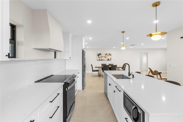 22274 SW 61st Ave, Boca Raton, FL 33428 - kitchen with appliances with stainless steel finishes, white cabinetry, an island with sink, decorative light fixtures, and recessed lighting