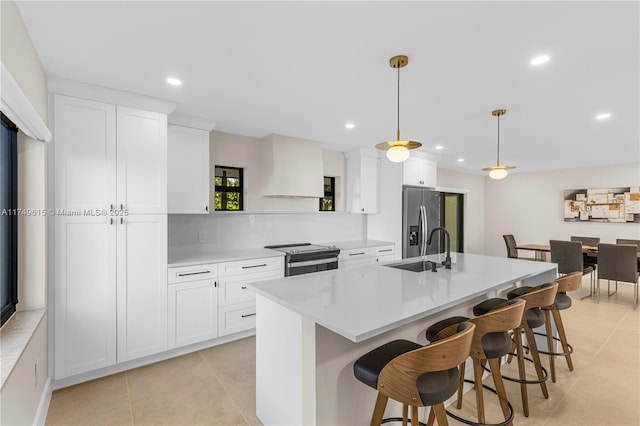 22274 SW 61st Ave, Boca Raton, FL 33428 - kitchen featuring stainless steel appliances, light tile patterned flooring, recessed lighting, white cabinets, and an island with sink