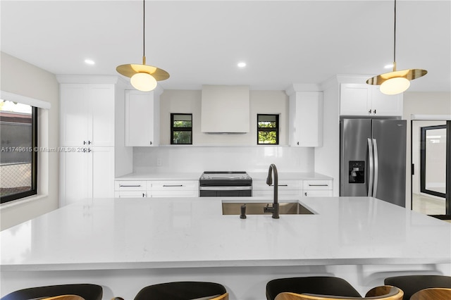 22274 SW 61st Ave, Boca Raton, FL 33428 - kitchen with appliances with stainless steel finishes, a breakfast bar area, premium range hood, and recessed lighting