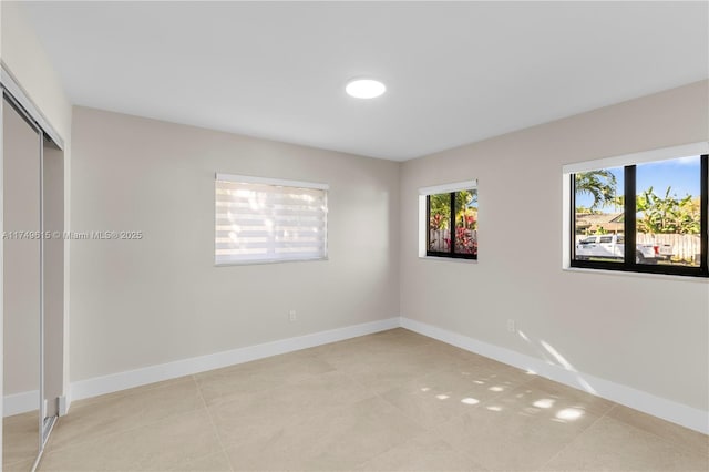 22274 SW 61st Ave, Boca Raton, FL 33428 - unfurnished bedroom with light tile patterned floors and a closet