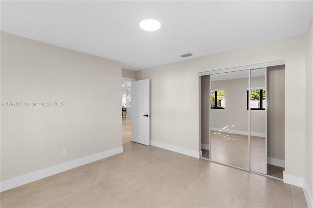 22274 SW 61st Ave, Boca Raton, FL 33428 - unfurnished bedroom with a closet and light tile patterned floors