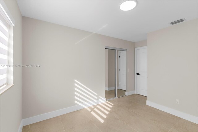 22274 SW 61st Ave, Boca Raton, FL 33428 - empty room with light tile patterned floors and baseboards