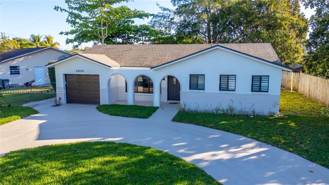 22274 SW 61st Ave, Boca Raton, FL 33428 - view of front of house with concrete driveway, an attached garage, brick siding, and stucco siding