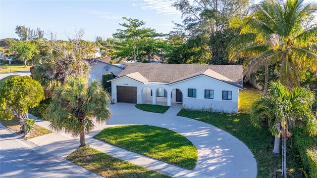 22274 SW 61st Ave, Boca Raton, FL 33428 - view of front of house featuring an attached garage, stucco siding, driveway, and a front lawn