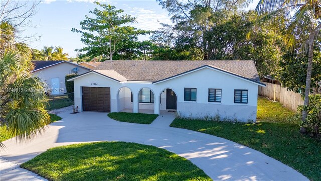 22274 SW 61st Ave, Boca Raton, FL 33428 - view of front facade featuring an attached garage, curved driveway, and stucco siding