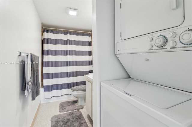 washroom with stacked washer and dryer and laundry area