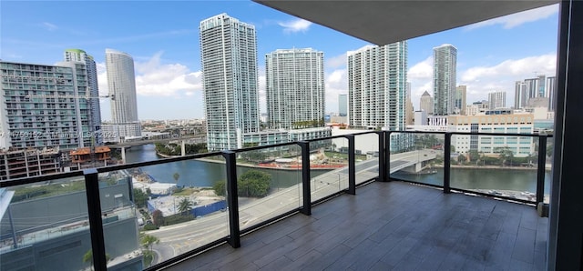 balcony with a water view and a city view