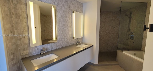 full bath featuring walk in shower, a bath, tasteful backsplash, and a sink