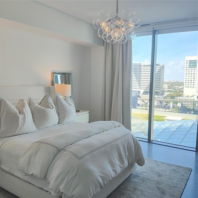 bedroom with a chandelier, a city view, and access to outside