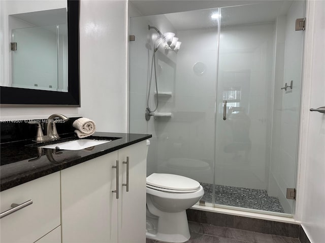 full bath with tile patterned flooring, vanity, toilet, and a shower stall