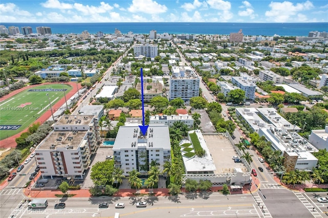 birds eye view of property featuring a water view and a view of city