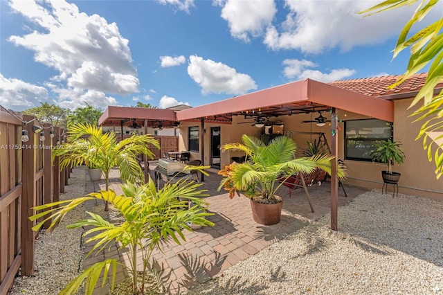 exterior space with a fenced backyard and ceiling fan