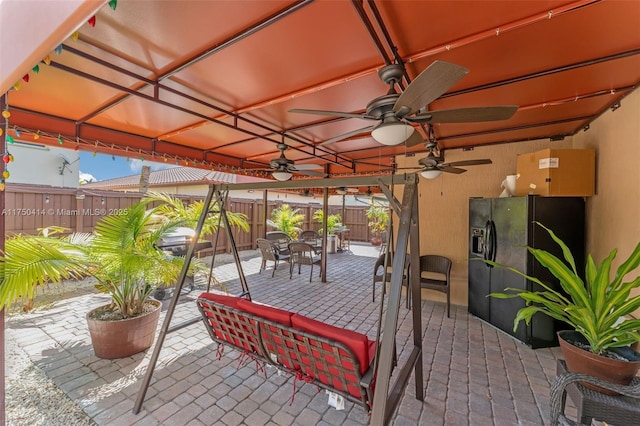 view of patio / terrace featuring a fenced backyard, outdoor dining area, and a ceiling fan