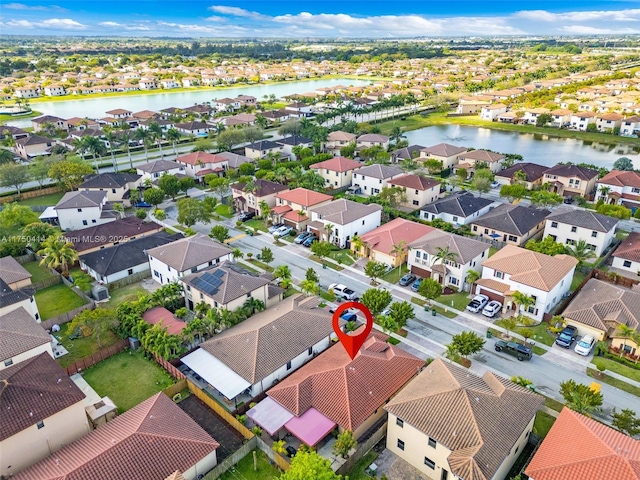 bird's eye view with a water view and a residential view