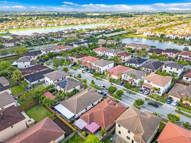 drone / aerial view with a water view and a residential view