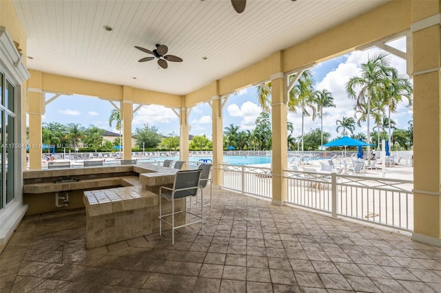 sunroom with wood ceiling and ceiling fan