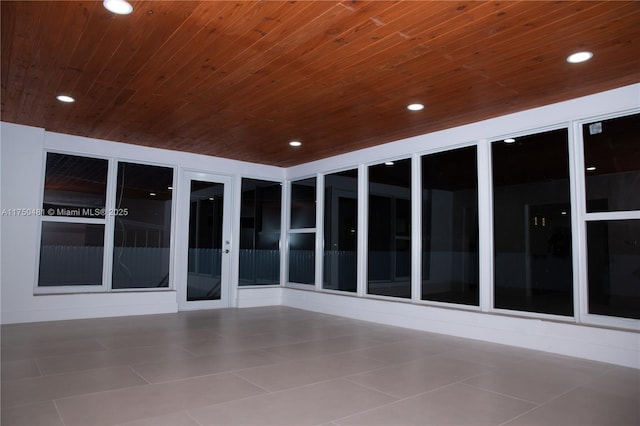 unfurnished sunroom with wooden ceiling