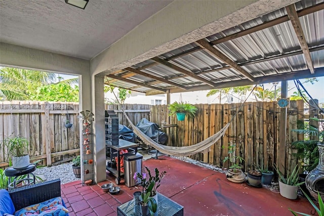 view of patio featuring a fenced backyard and a grill