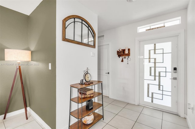 entryway featuring light tile patterned floors, visible vents, and baseboards