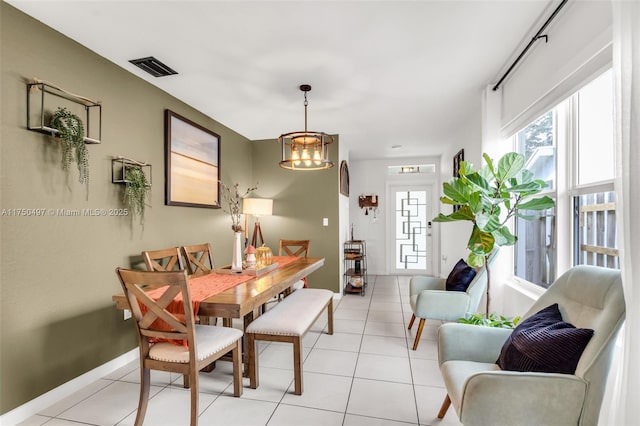 dining room with light tile patterned floors, baseboards, and visible vents