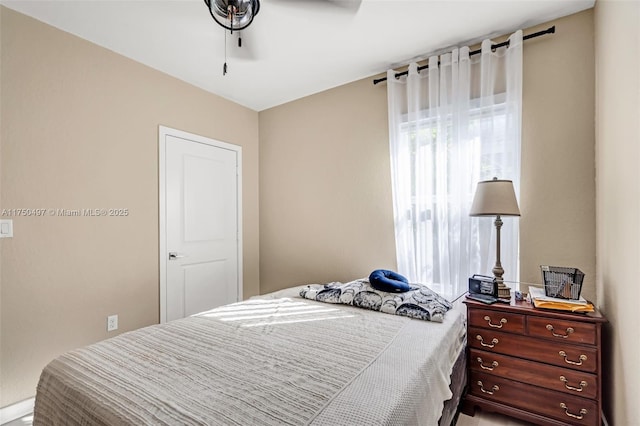 bedroom with multiple windows and a ceiling fan