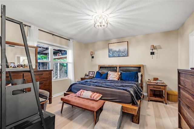 bedroom featuring light wood-style floors and baseboards