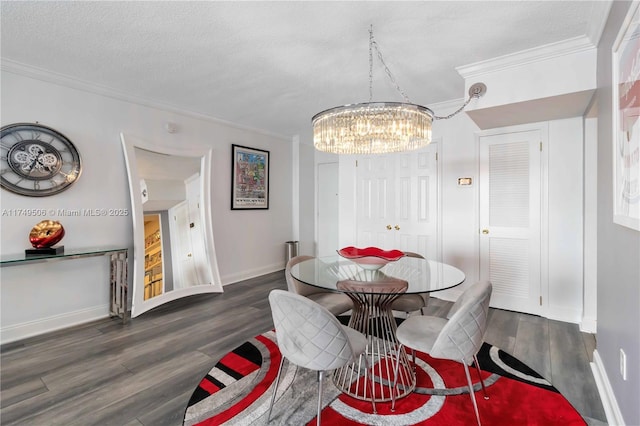 dining area with dark wood-style floors, crown molding, a textured ceiling, a chandelier, and baseboards