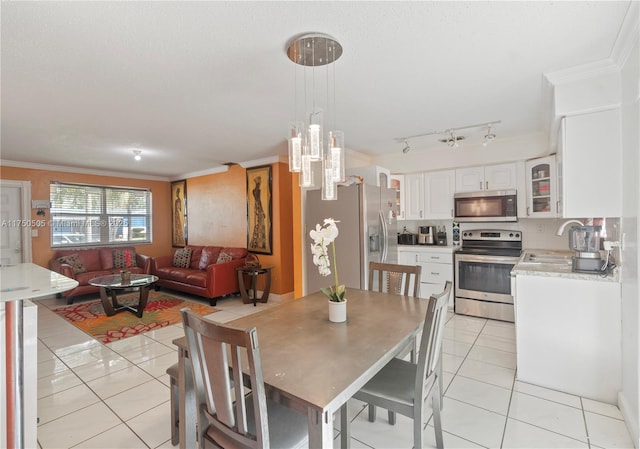 dining area featuring light tile patterned floors and crown molding