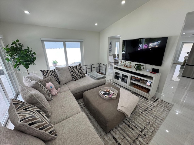 living area featuring lofted ceiling and recessed lighting