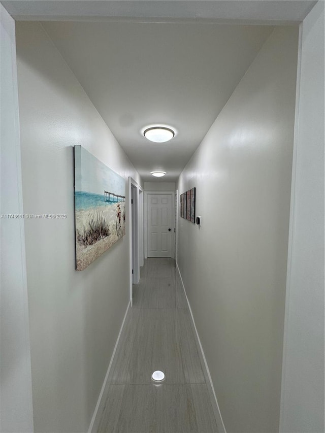 corridor featuring baseboards