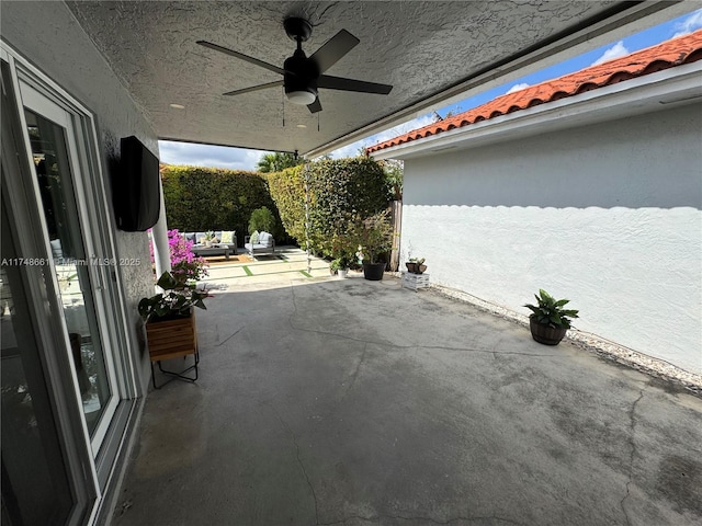 view of patio / terrace with ceiling fan and fence